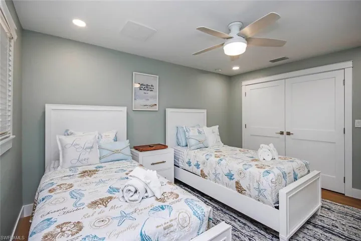 Bedroom with a closet, ceiling fan, recessed lighting, and wood finished floors