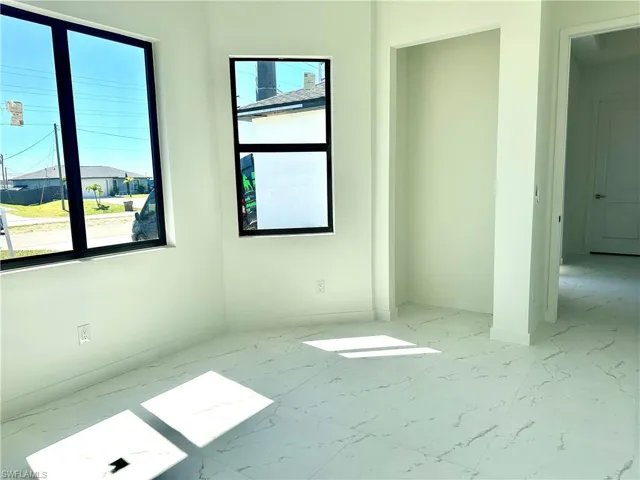 Empty room featuring marble finish floor and baseboards