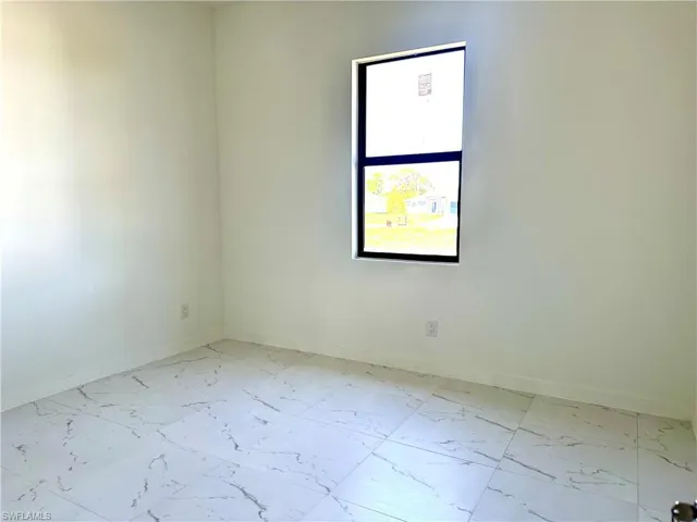 Empty room with marble finish floor and baseboards