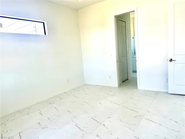 Empty room with marble finish floor and baseboards