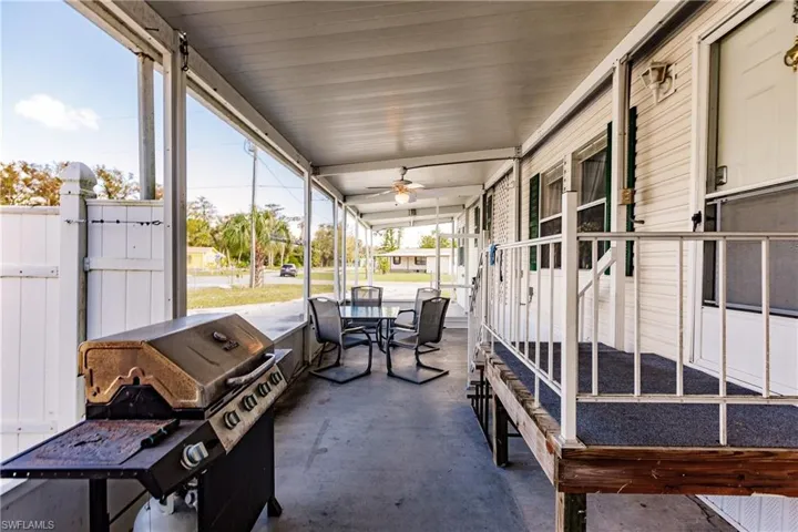 Unfurnished sunroom featuring ceiling fan