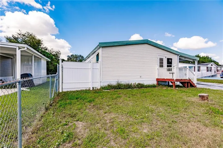 View of side of home featuring a yard