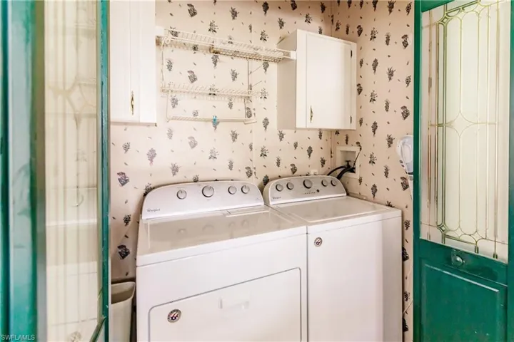 Washroom featuring washing machine and clothes dryer