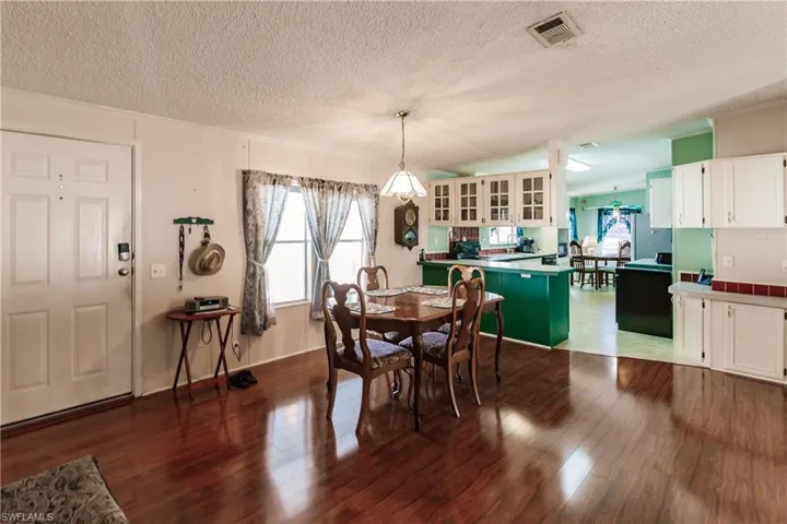 Dining room featuring dark hardwood / wood-style floors and a textured ceiling