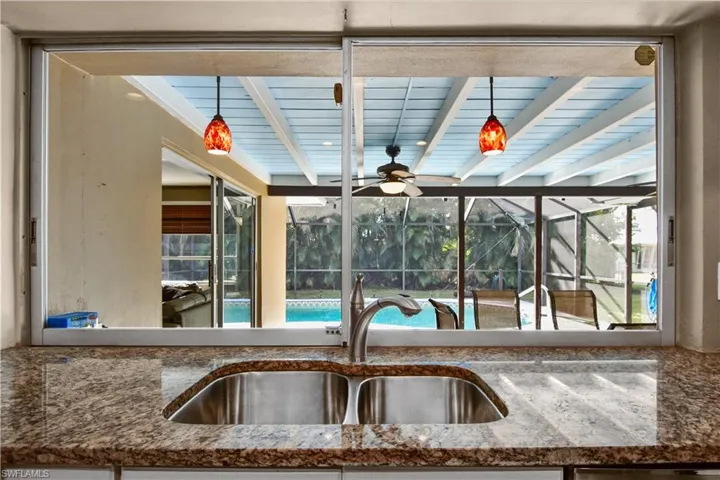 What a lovely view from your kitchen sink, overlooking the pool area with beamed ceiling