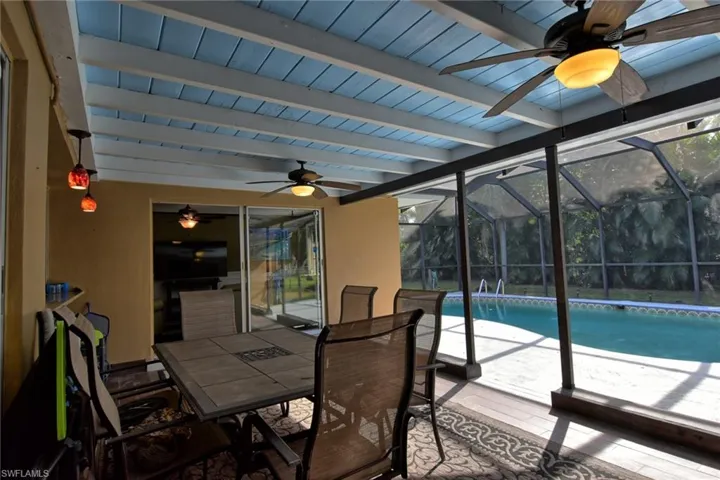 Sunroom / solarium featuring beamed ceiling