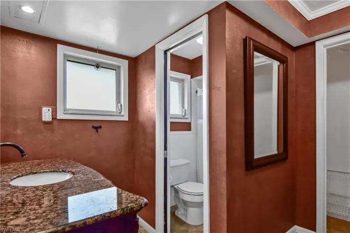 Primary bathroom with water closet, walk-in shower and two closets.