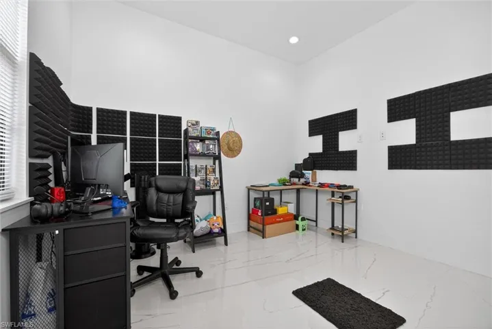 Room featuring white walls and white tile flooring