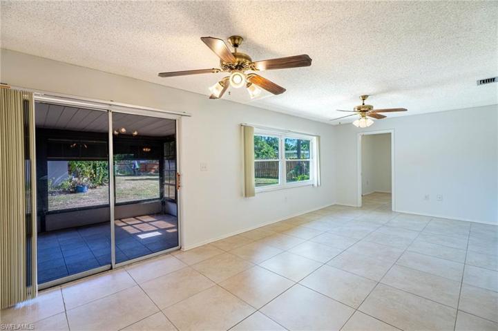 Dining room facing screened lanai and den off to the right.