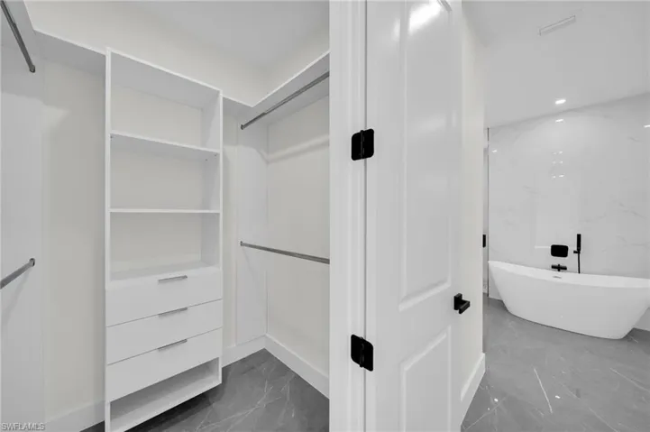 Spacious closet with marble finish floor