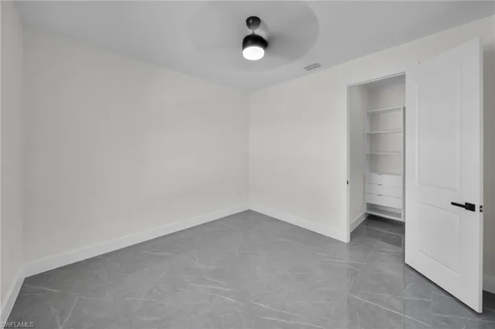 Unfurnished bedroom featuring visible vents, ceiling fan, and baseboards