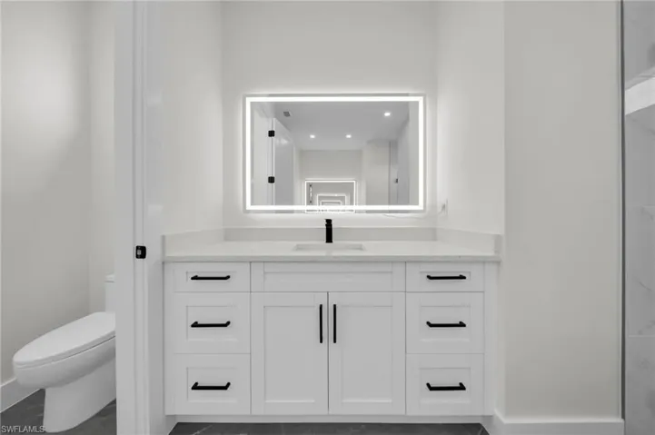 Bathroom featuring vanity and toilet