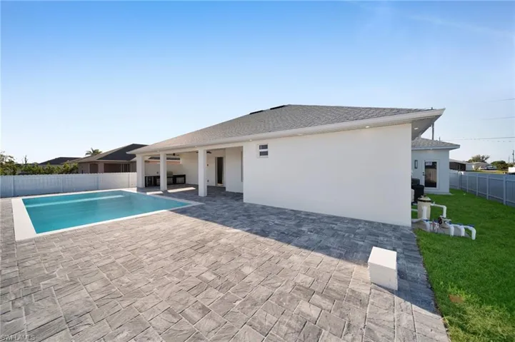 View of pool featuring a patio area, a fenced backyard, a fenced in pool, and a yard