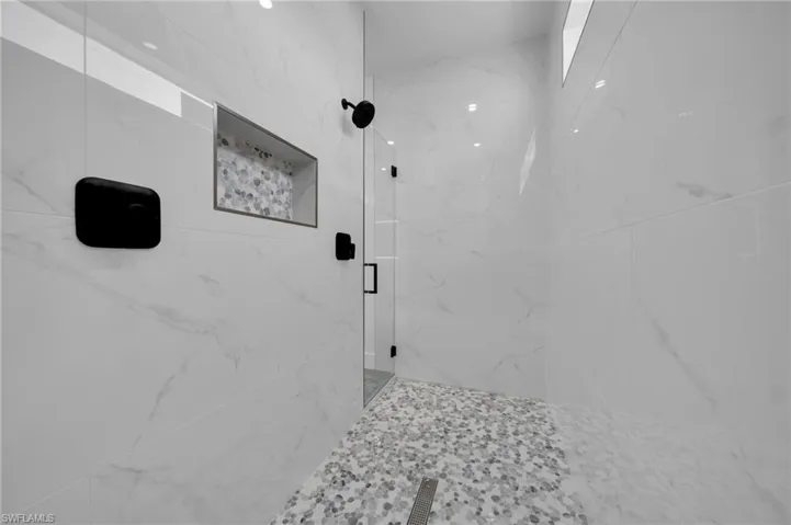 Bathroom with a marble finish shower