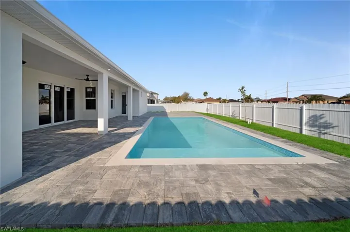 View of swimming pool with a patio, a fenced backyard, a ceiling fan, and a fenced in pool