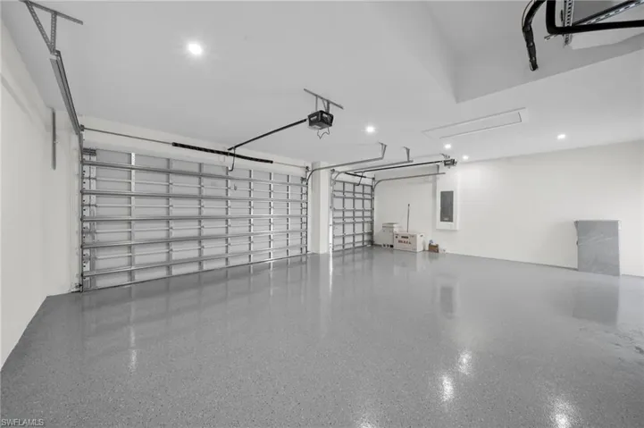 Garage with electric panel and a garage door opener