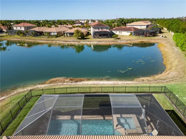 Aerial perspective of suburban area featuring a large body of water