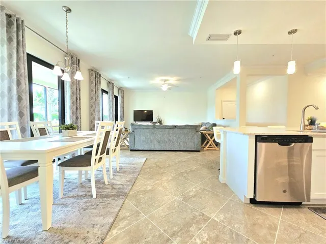Dining area with light tile patterned flooring, visible vents, and crown molding