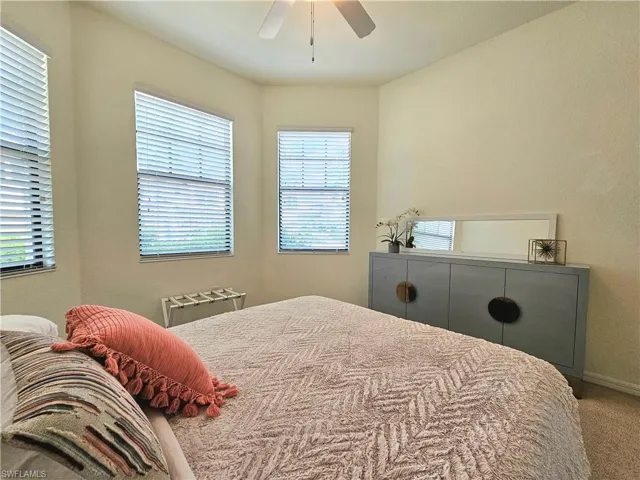 Bedroom with baseboards, a ceiling fan, and carpet flooring
