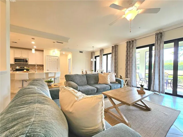 Living area with light tile patterned flooring, visible vents, ceiling fan, and recessed lighting