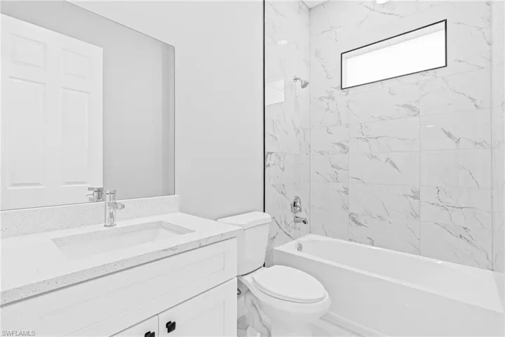 Bathroom featuring  shower combination and vanity