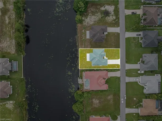 Aerial view of property's location with nearby suburban area and a large body of water