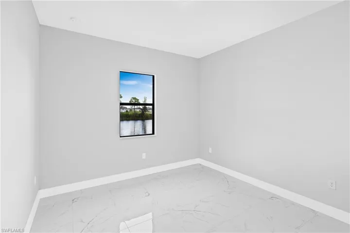 Spare room featuring light marble finish flooring