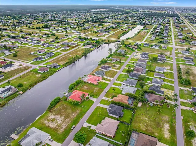 Aerial view of residential area featuring a nearby body of water