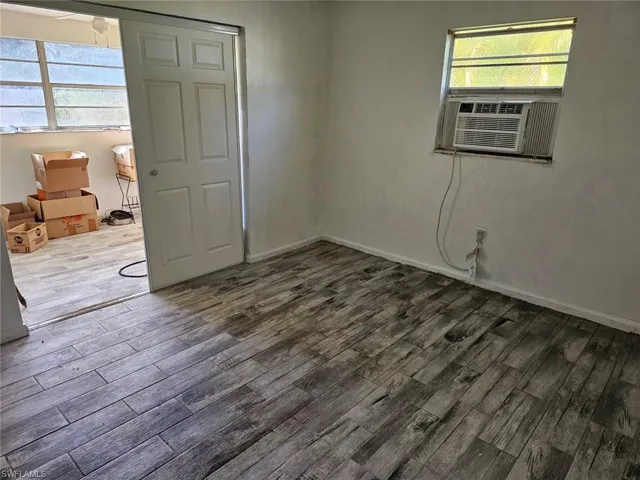 SpareBedroom room featuring wood finished floors and cooling unit