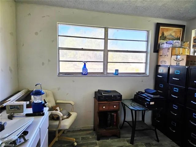 Office featuring a textured ceiling and healthy amount of natural light