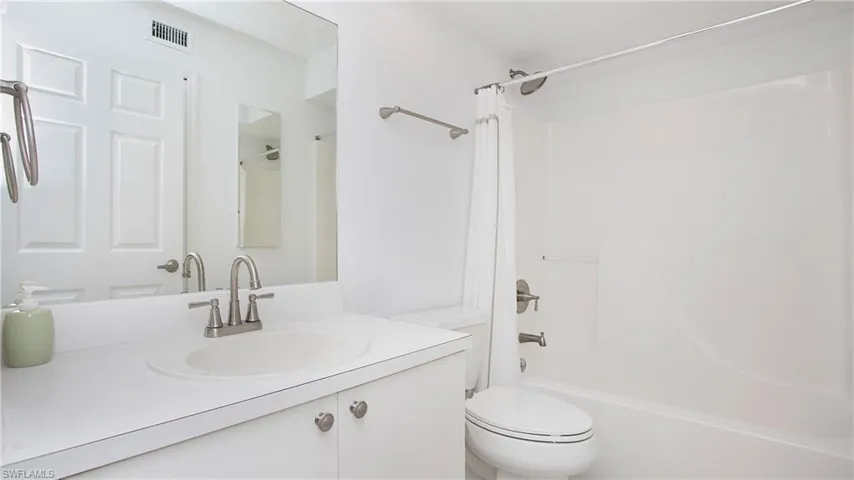 Second Full bath with toilet,  shower combination, and vanity