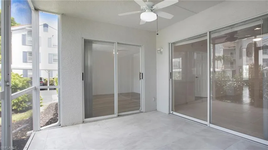 Unfurnished sunroom with a ceiling fan and plenty of natural light