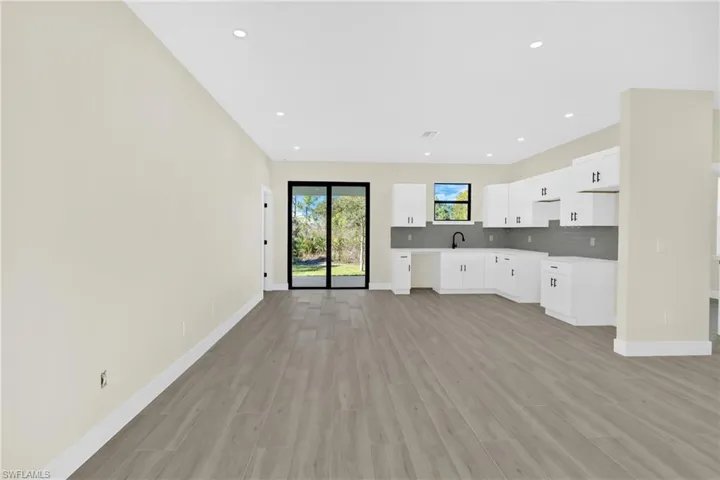 Unfurnished living room with light wood-type flooring and recessed lighting