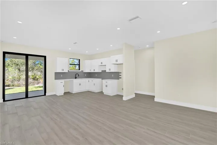 Unfurnished living room with recessed lighting and light wood finished floors