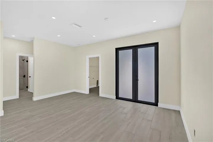 Unfurnished room with light wood finished floors and recessed lighting