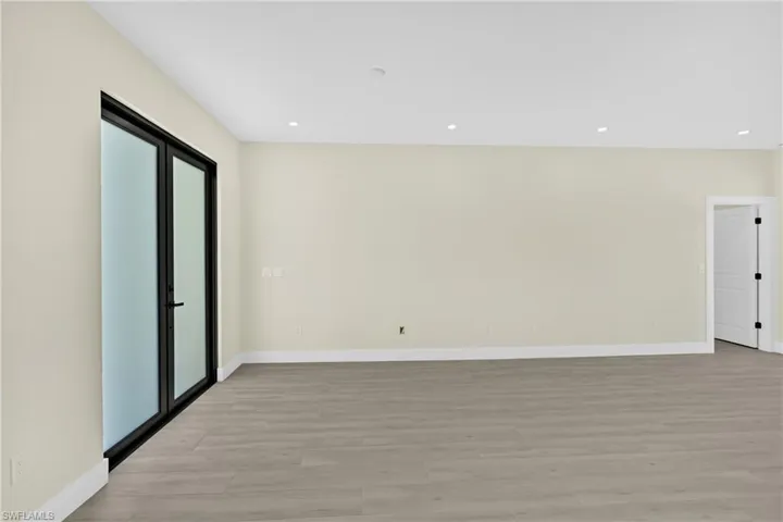 Spare room with light wood-type flooring and recessed lighting