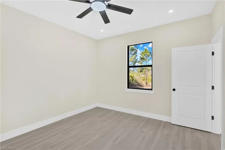 Empty room featuring light wood-type flooring, recessed lighting, and ceiling fan