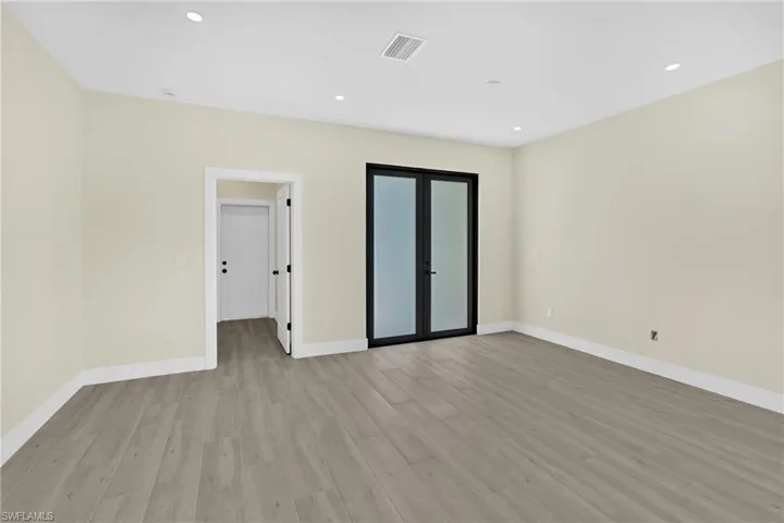 Spare room featuring light wood finished floors and recessed lighting