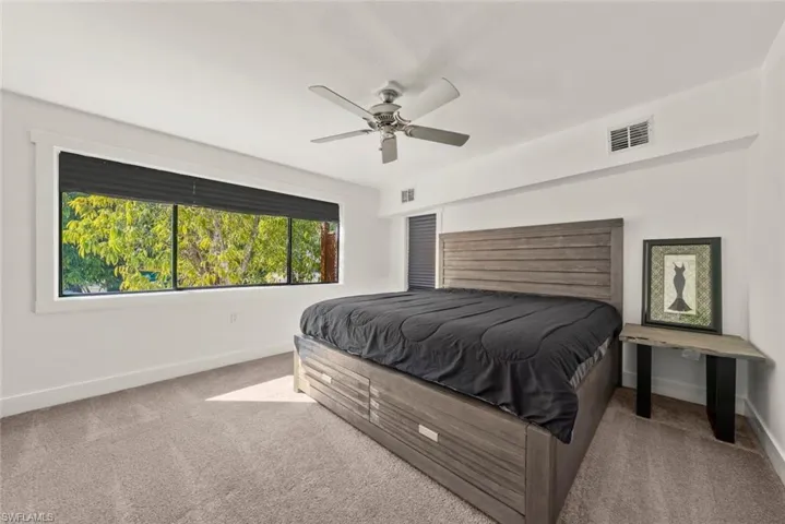 Bedroom with light carpet and ceiling fan