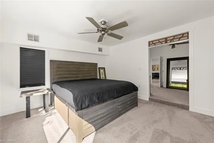 Bedroom featuring light colored carpet and a ceiling fan