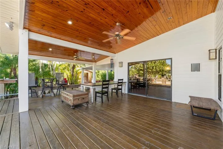 Deck featuring outdoor dining area and a ceiling fan