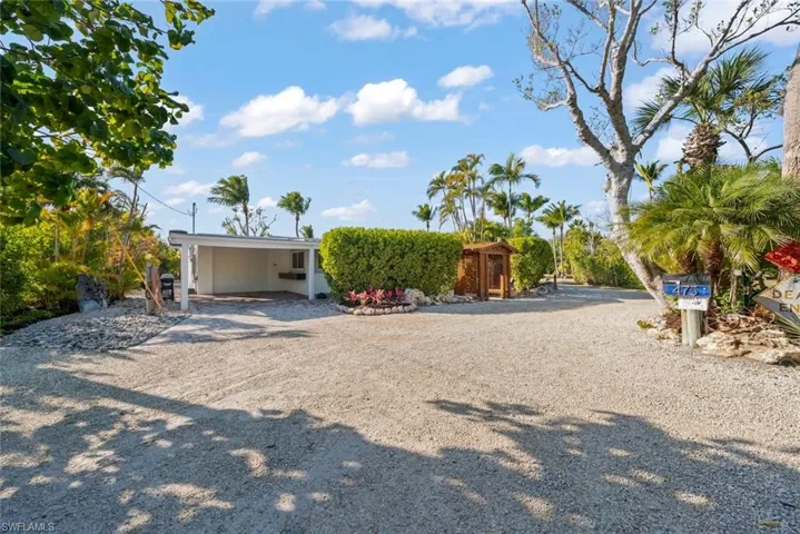 View of front of home with driveway and an attached carport