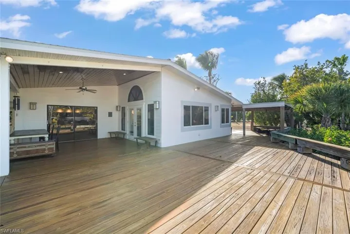 Deck with french doors and a ceiling fan