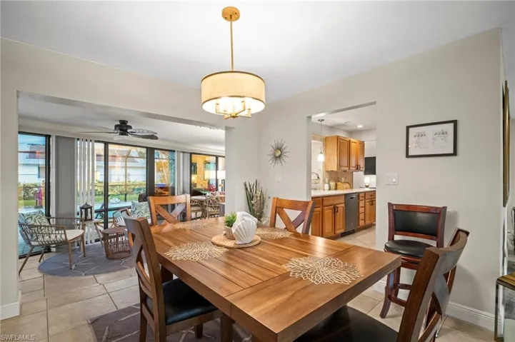 Dining area featuring light tile patterned floors and ceiling fan