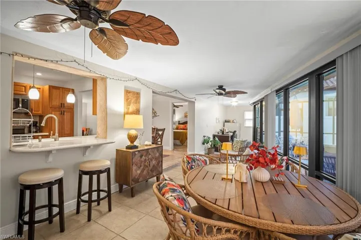 Dining area featuring ceiling fan and light tile patterned floors