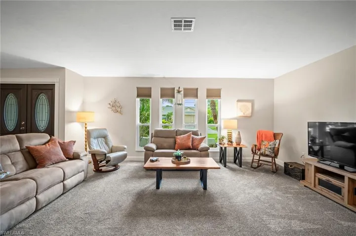 Living room featuring carpet floors and baseboards
