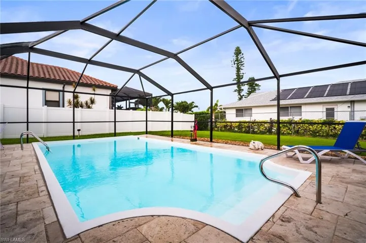 View of swimming pool with a patio and a lanai