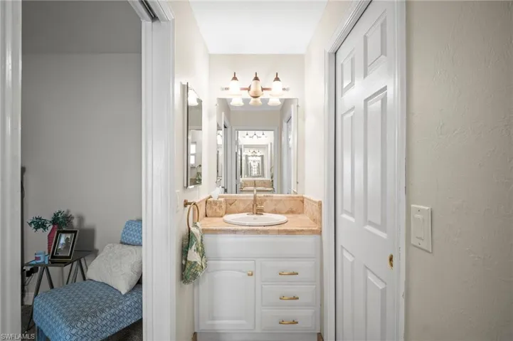 Bathroom with vanity and a chandelier