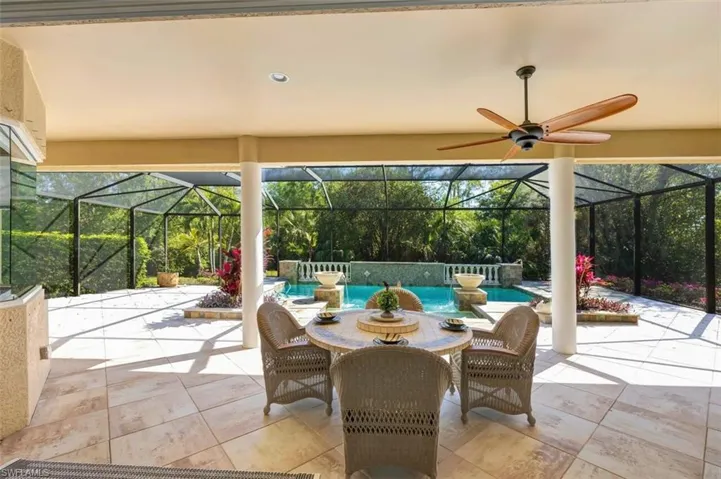 View of patio featuring an outdoor pool, a lanai, and a ceiling fan