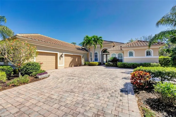 Mediterranean / spanish house featuring stucco siding, decorative driveway, an attached garage, and a tile roof